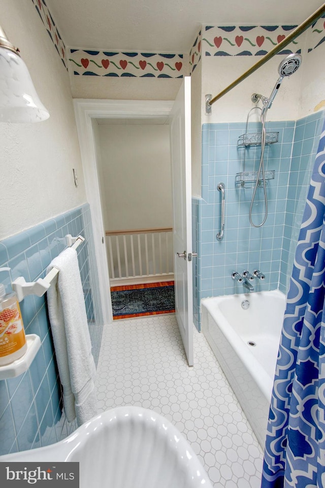 bathroom featuring shower / bath combo and tile walls