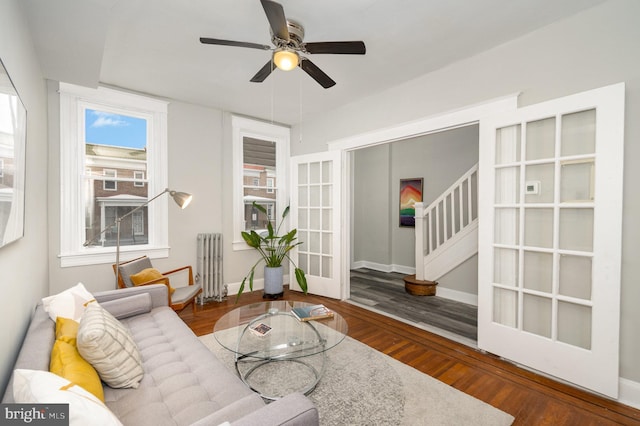 living room featuring ceiling fan, wood-type flooring, and radiator heating unit