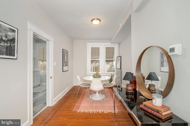 dining room with plenty of natural light and wood-type flooring