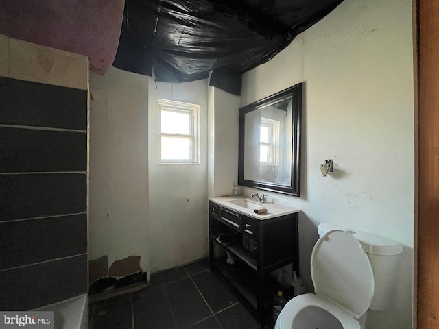 bathroom with tile patterned flooring, toilet, and vanity