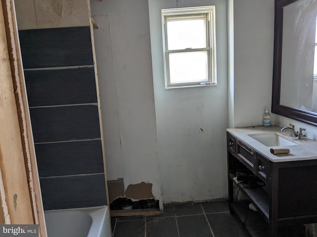 bathroom featuring vanity, tile patterned floors, and a tub