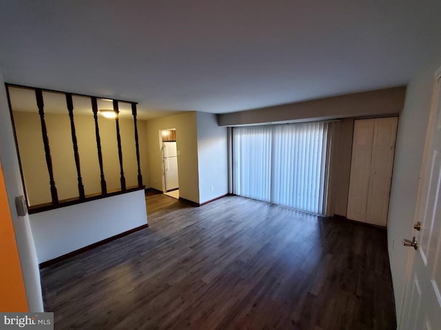 unfurnished room with dark hardwood / wood-style floors