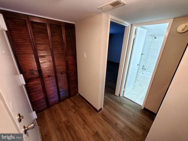 hallway with dark hardwood / wood-style floors