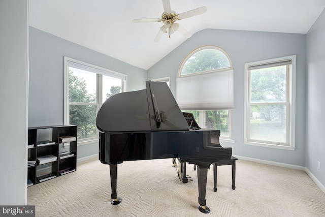 miscellaneous room featuring a wealth of natural light, ceiling fan, light colored carpet, and vaulted ceiling