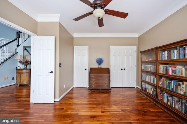 living area with dark hardwood / wood-style flooring, ceiling fan, and crown molding