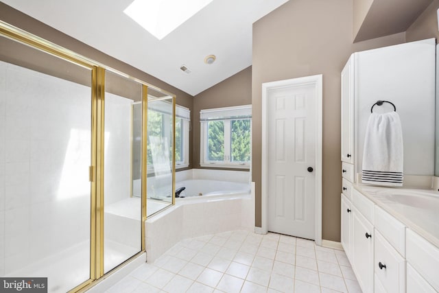 bathroom featuring separate shower and tub, lofted ceiling with skylight, tile patterned flooring, and vanity