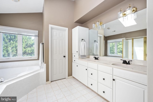 bathroom with tile patterned floors, vanity, a relaxing tiled tub, and lofted ceiling