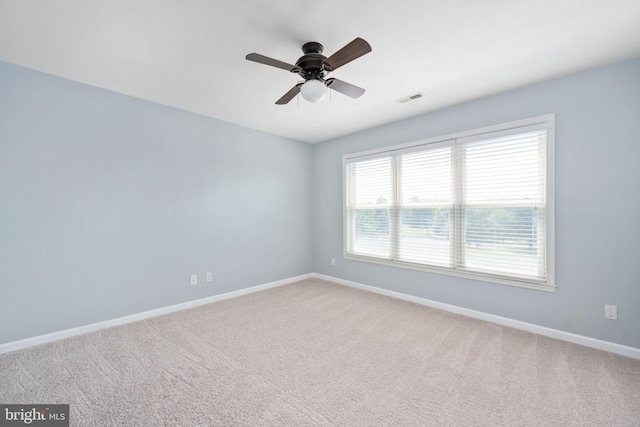 empty room with ceiling fan and carpet floors