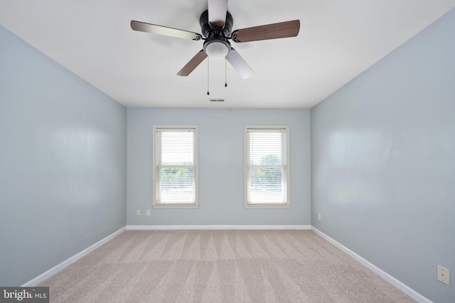 spare room with light carpet and ceiling fan