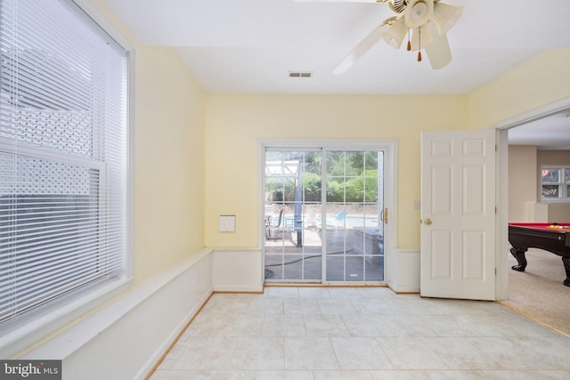 doorway to outside featuring ceiling fan, light tile patterned floors, and pool table