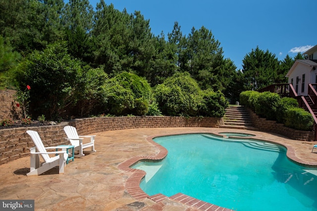 view of pool featuring an in ground hot tub and a patio