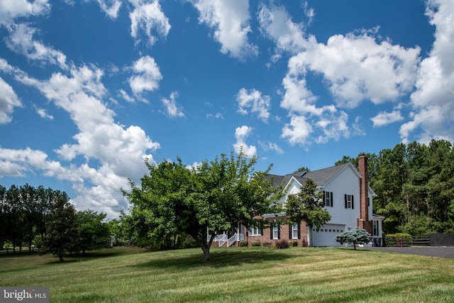 view of front of house with a front yard and a garage