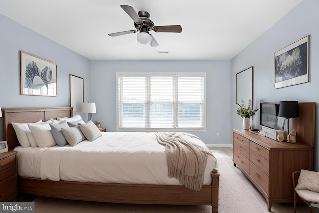 bedroom with ceiling fan and light carpet