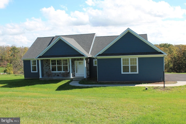 view of front of house featuring covered porch and a front lawn