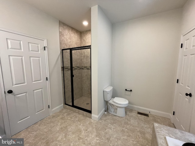 bathroom featuring walk in shower and toilet