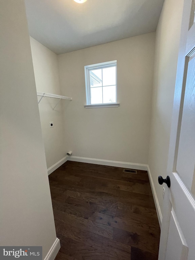 clothes washing area featuring dark wood-type flooring and hookup for an electric dryer