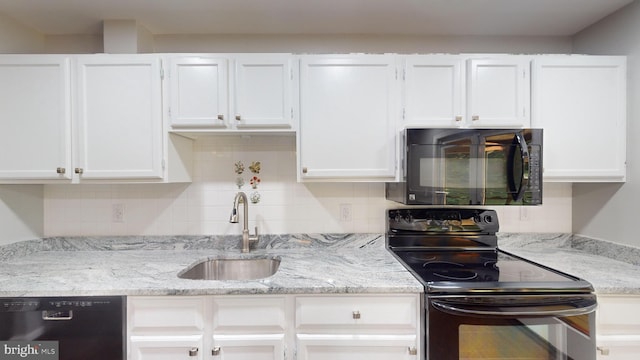 kitchen featuring white cabinetry, sink, decorative backsplash, and black appliances