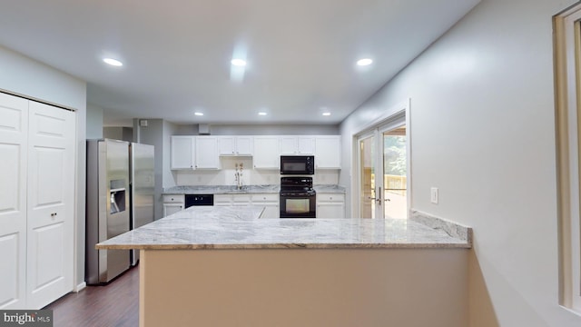 kitchen featuring white cabinetry, dark hardwood / wood-style floors, light stone countertops, black appliances, and kitchen peninsula