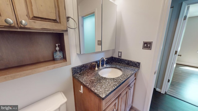 bathroom featuring hardwood / wood-style flooring and vanity