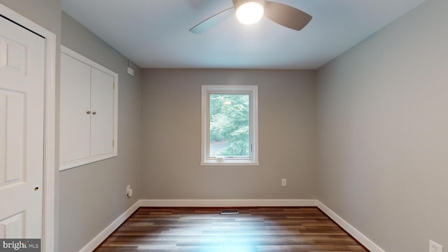 unfurnished bedroom with dark wood-type flooring and ceiling fan