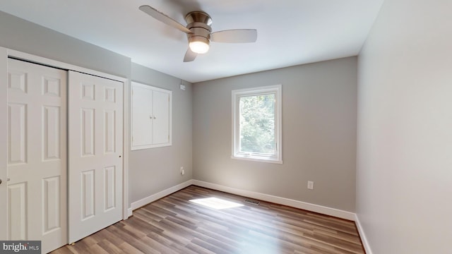 unfurnished bedroom featuring a closet, ceiling fan, and light hardwood / wood-style flooring