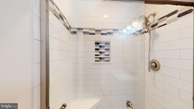 bathroom with a tile shower