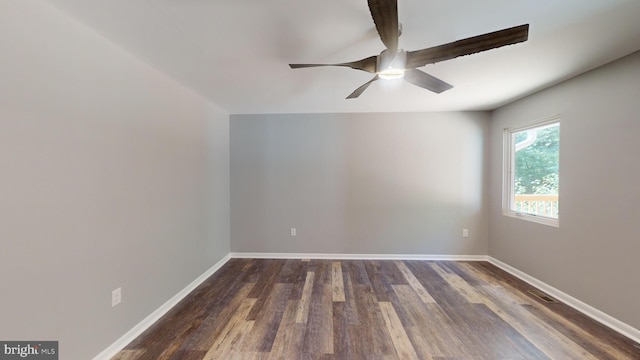 empty room with ceiling fan and dark hardwood / wood-style flooring