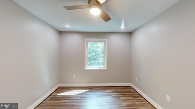 spare room with hardwood / wood-style flooring and ceiling fan