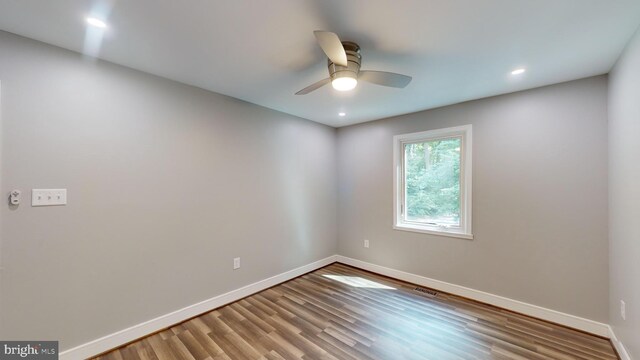 empty room with hardwood / wood-style flooring and ceiling fan