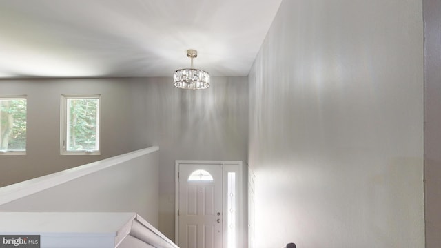 foyer entrance with a chandelier