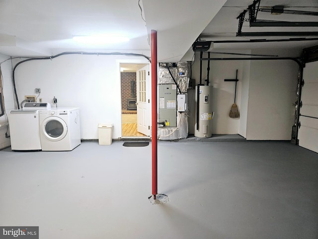 basement featuring heating unit, independent washer and dryer, and water heater