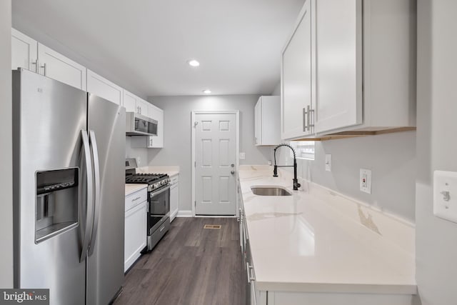 kitchen with white cabinets, stainless steel appliances, and sink