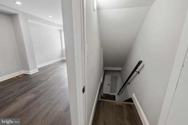 stairs featuring wood-type flooring