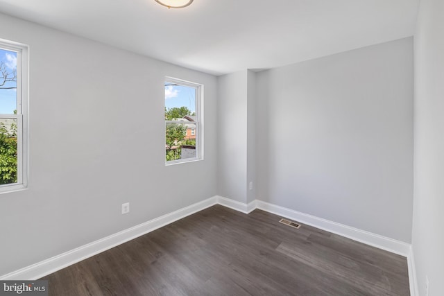 unfurnished room featuring dark hardwood / wood-style floors