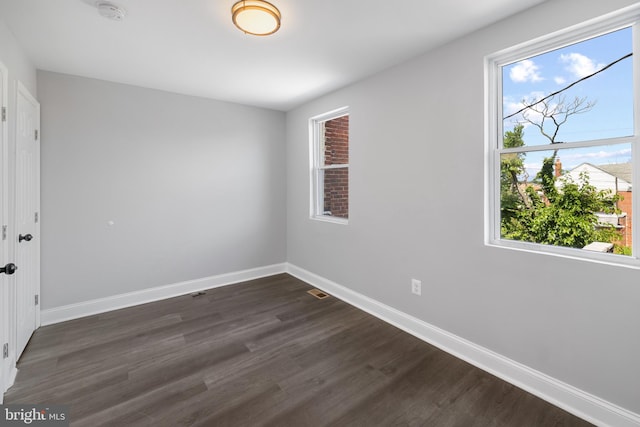 empty room featuring dark wood-type flooring