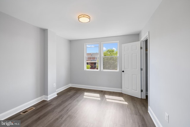 unfurnished room featuring dark hardwood / wood-style floors