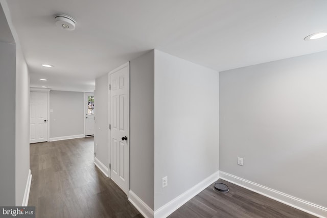 hallway with dark hardwood / wood-style flooring