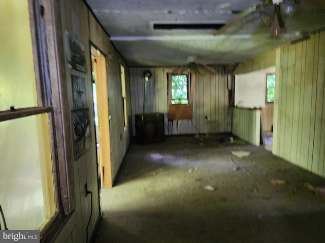 empty room featuring wood walls