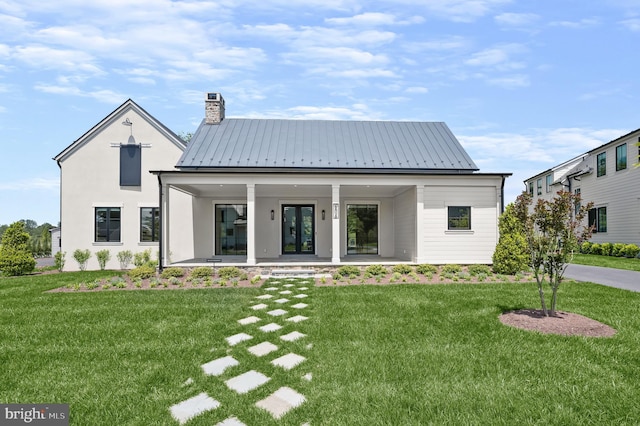 exterior space with covered porch and a yard