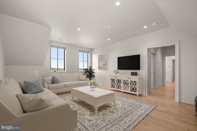 living room featuring lofted ceiling and light hardwood / wood-style flooring