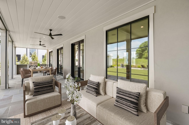 sunroom with ceiling fan and wooden ceiling