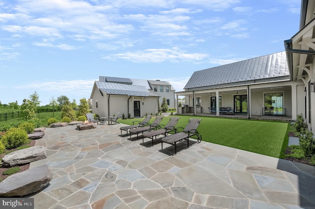 view of patio / terrace with a fire pit and an outdoor structure