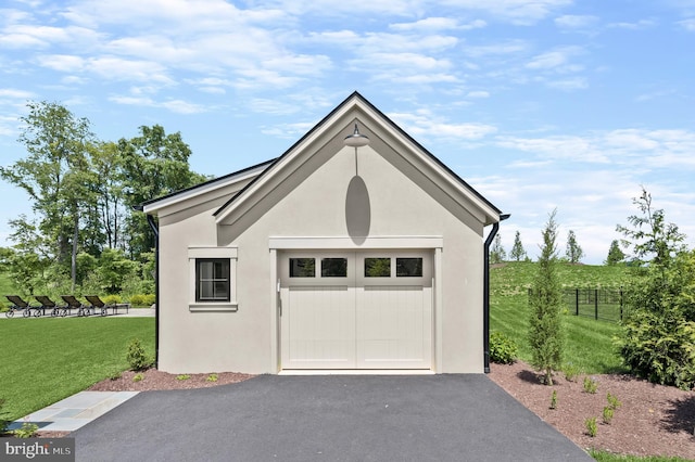 garage featuring a lawn