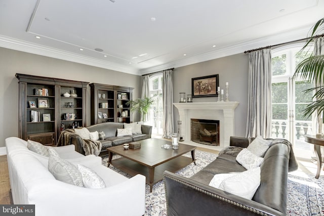 living room with crown molding and light hardwood / wood-style floors