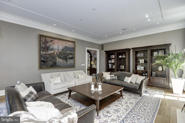 living room featuring light wood-type flooring and crown molding