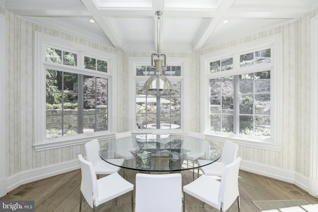 sunroom featuring a chandelier, coffered ceiling, and a healthy amount of sunlight