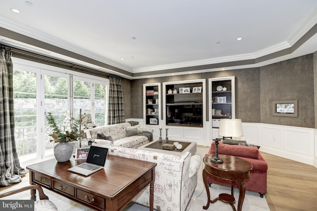 living room featuring light hardwood / wood-style floors, a healthy amount of sunlight, and crown molding