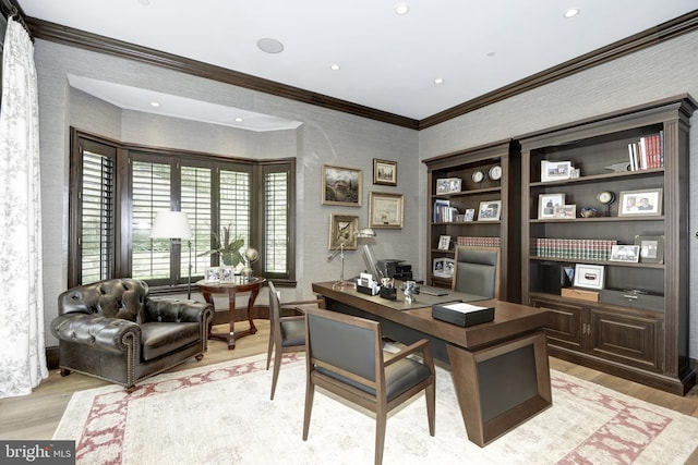 home office featuring light hardwood / wood-style flooring and crown molding