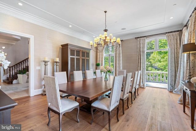 dining area featuring ornamental molding, a notable chandelier, and light hardwood / wood-style floors