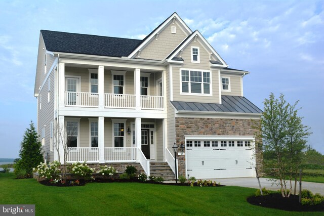 modern farmhouse featuring a garage, a porch, and a front lawn